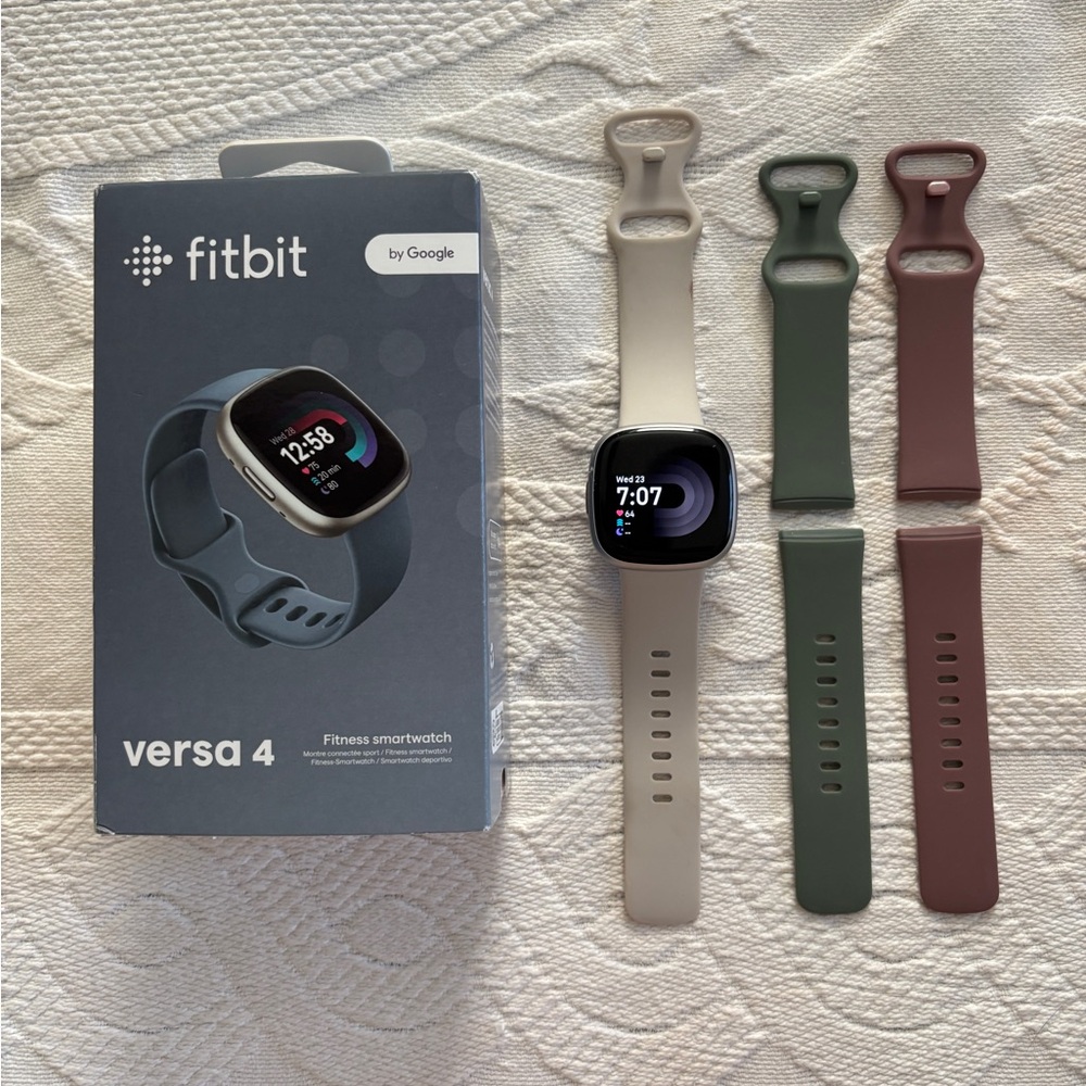 Fitbit Versa 4 with additional bands.